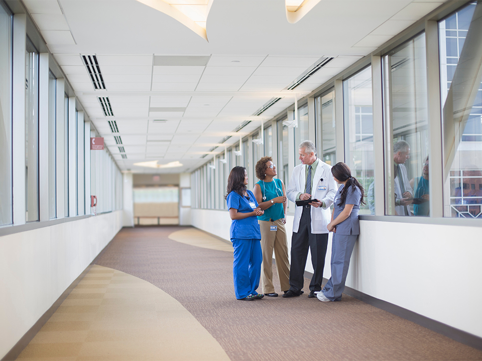 Doctor and nurses talking in hospital hallway